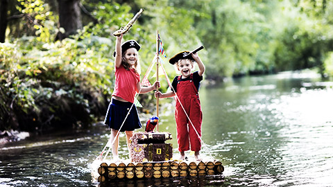 A couple of little children pretending to be pirates