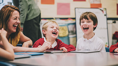 A teacher having a laugh with a group of students