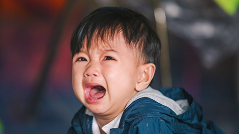 A young child upset and crying