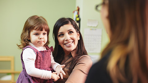 A parent and child talking to a teacher