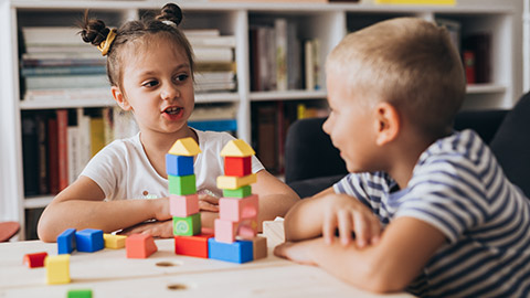 2 young children talking to each other