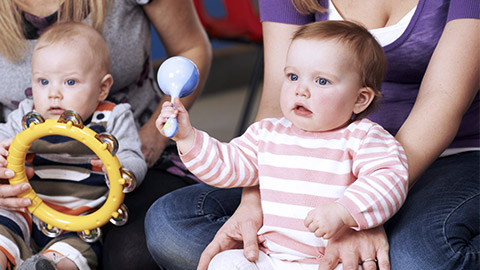 Babies holding musicla instruments