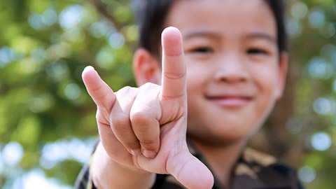 Happy child looking at camera wearing camos