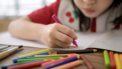 Close-up hands of child drawing