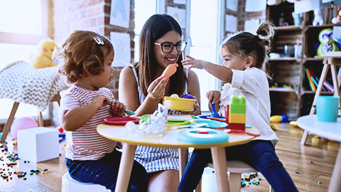 Teacher and toddlers playing toys