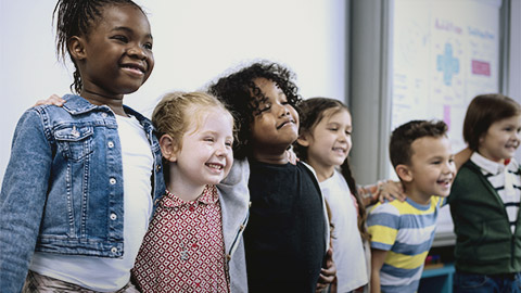 Diverse children standing infront of the class