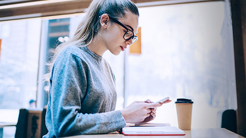 Woman typing on phone