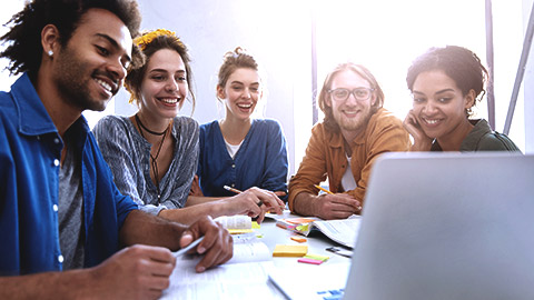 Mixed race surrounded on computer