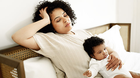 Tired mother holding a baby