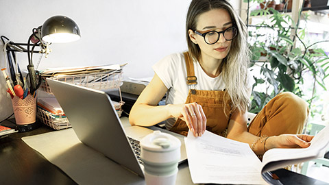 Young woman flipping on papers