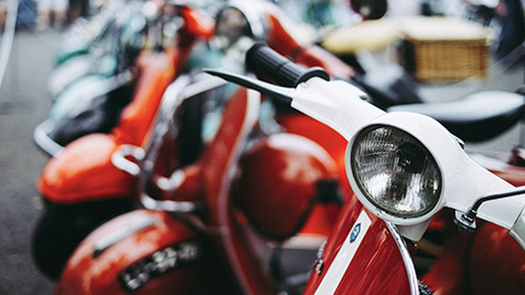 A close view of a group of scooters parked on a street