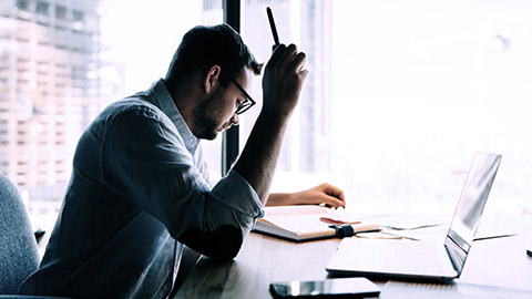 A man analyzing the business papers