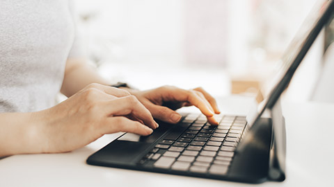 A close view of a person typing on a keyboard