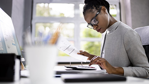 woman auditing with calculator