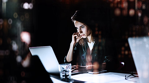 Young woman working at night in the office