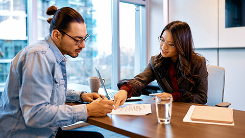 An accountant and client discussing financial matters in an office