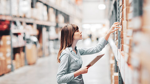 A person checking inventory in a factory