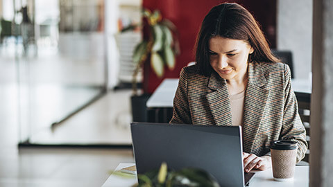 A person rading legislation on a latop in an office