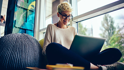 A designer working on a laptop in a relaxed environment