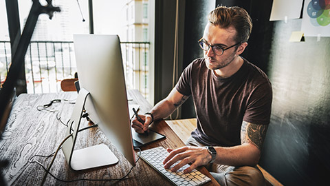 A designer working on concepts on a desktop computer