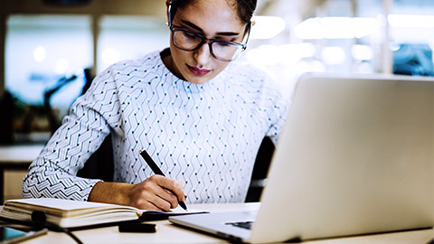 woman writing with computer