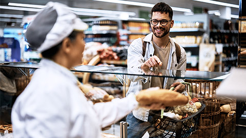 Young man buying bread