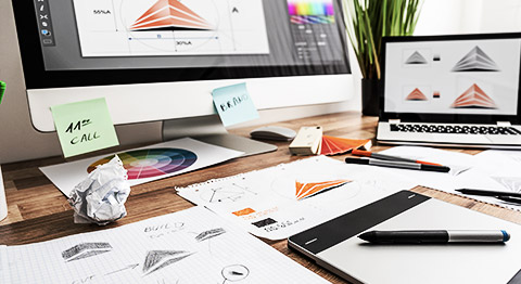 An artist's table full of scratch papers and studies