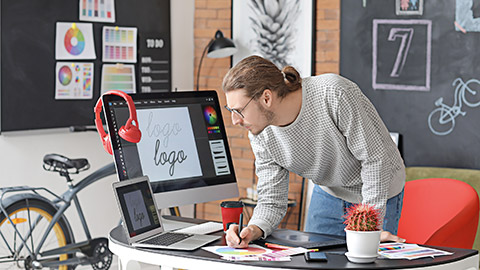 Young male designer working in office