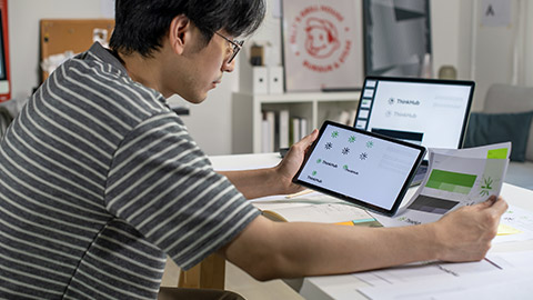 graphic designer working in an office studio, using tablet, designing logos