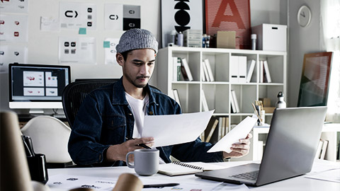 a young graphic designer looking optimistic