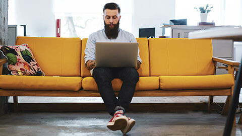 A manager working on a report on a laptop