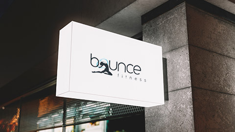 An illuminated sign outside Bounce Fitness