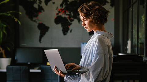 A manager working on a plan on a laptop