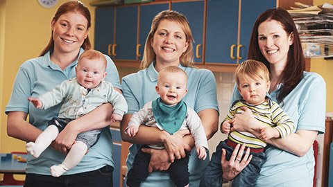 A group of childcare workers with infants