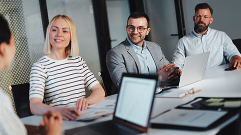 A group of coworkers discussing a project in a meeting room