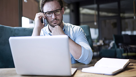 Pensive businessman working on difficult problem