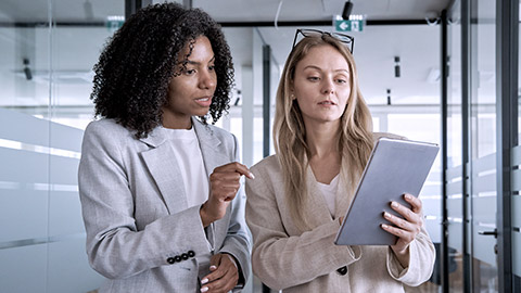 Two business women working on tablet