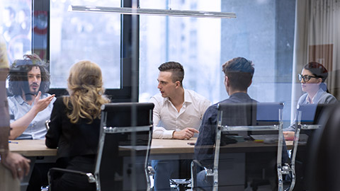 Group of office workers discussing project inside office