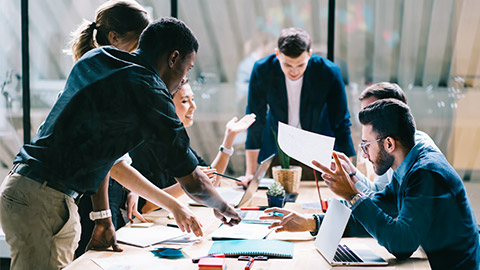 A group of people working together around a table