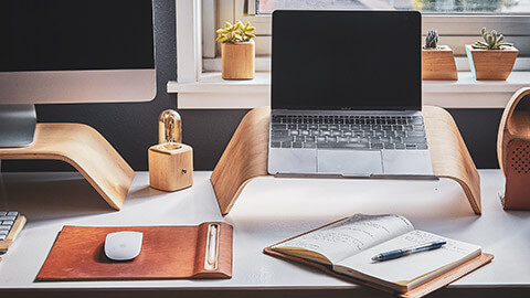 A desk with a variety of ergonomic devices displayed