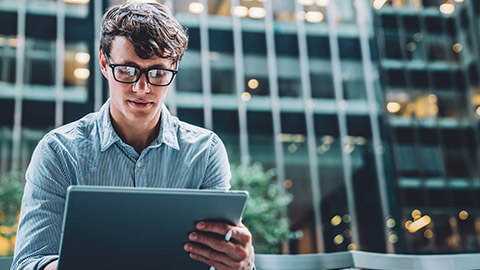 An accountant working on spreadsheets on a tablet device