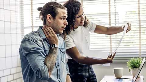 Two people conversing over procedures and policies inside a business