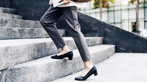 A person climbing up an office staircase