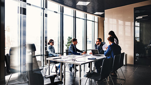 a group of professionals having a discussion in a conference room