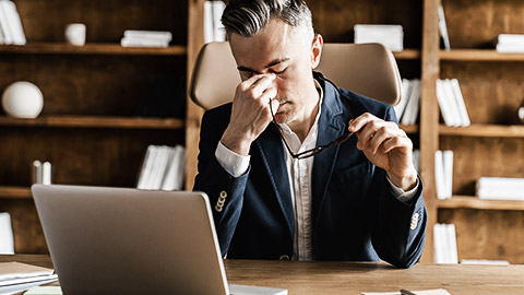 A person frustrated while in front of a laptop