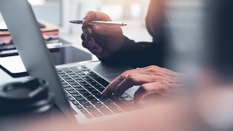 A close view of a person using a laptop