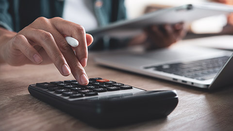 A close view of an accountant working at a desk