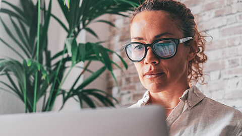 A close view of an account-type person working on a laptop