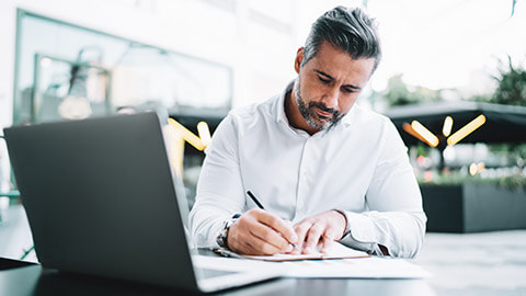 An accountant working on taxes in an outdoor setting