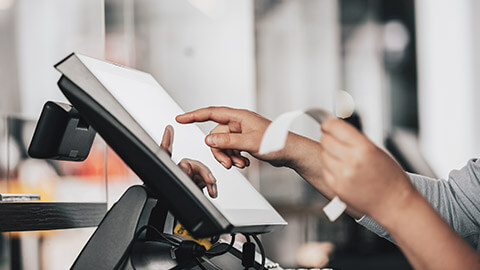 A business owner entering receipt information into a computer